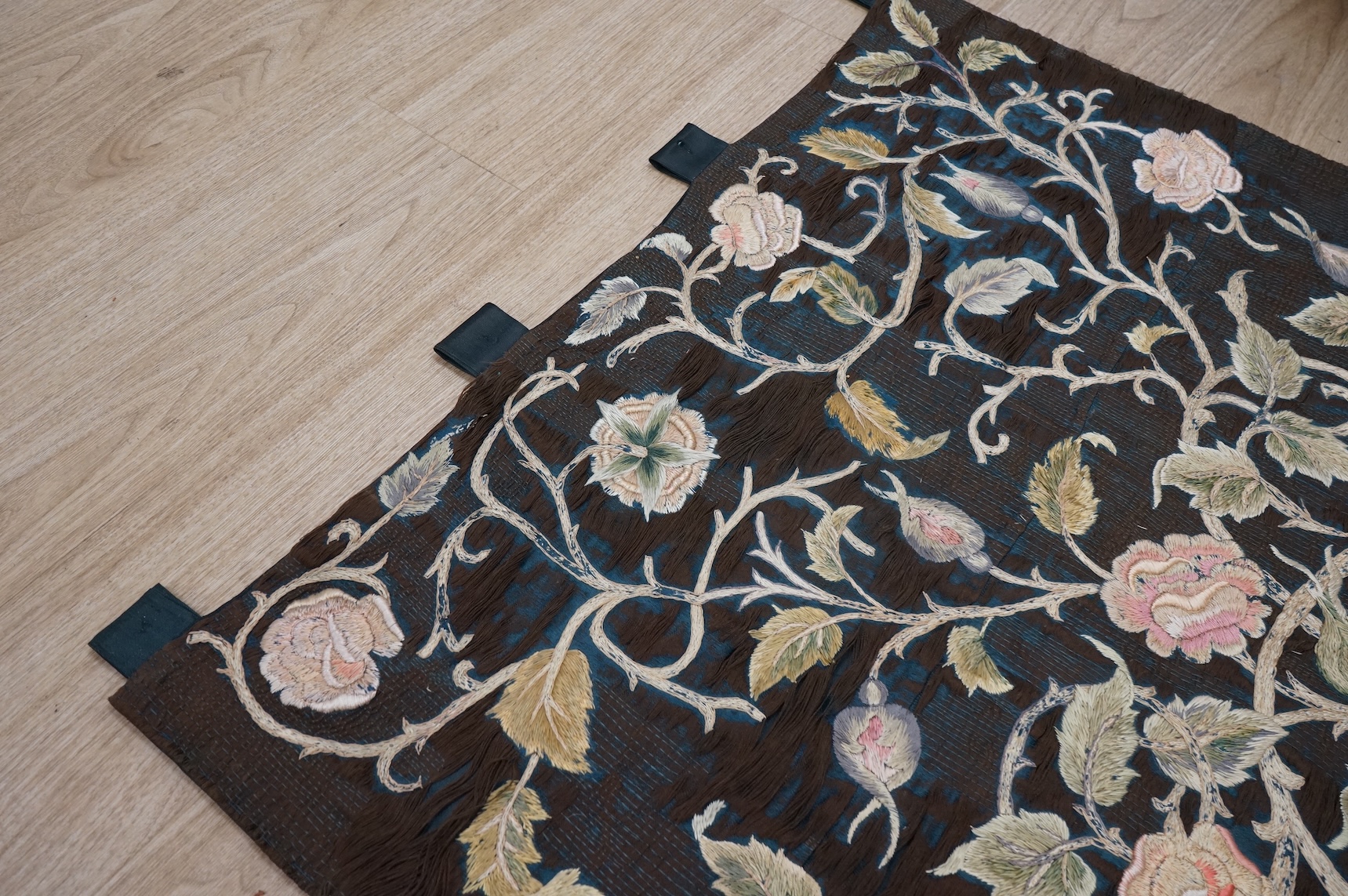A large Arts and Crafts silk embroidered wall hanging, embroidered in the manner of May Morris with a large central scrolling flowering rose tree and banner embroidered with Salve and a two row motto below;, Rose leaves